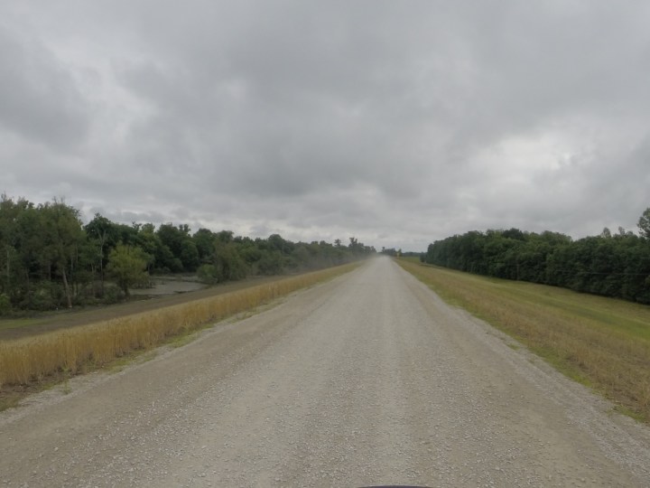 Hwy 465 - a gravel one-lane road on top of a levee